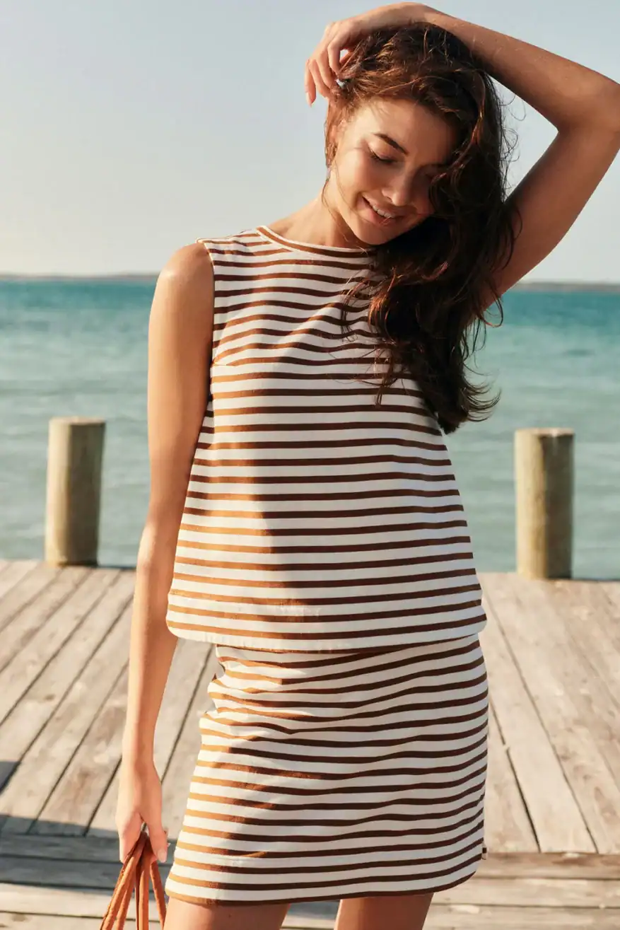 woman wearing LAKE striped skirt set at the beach