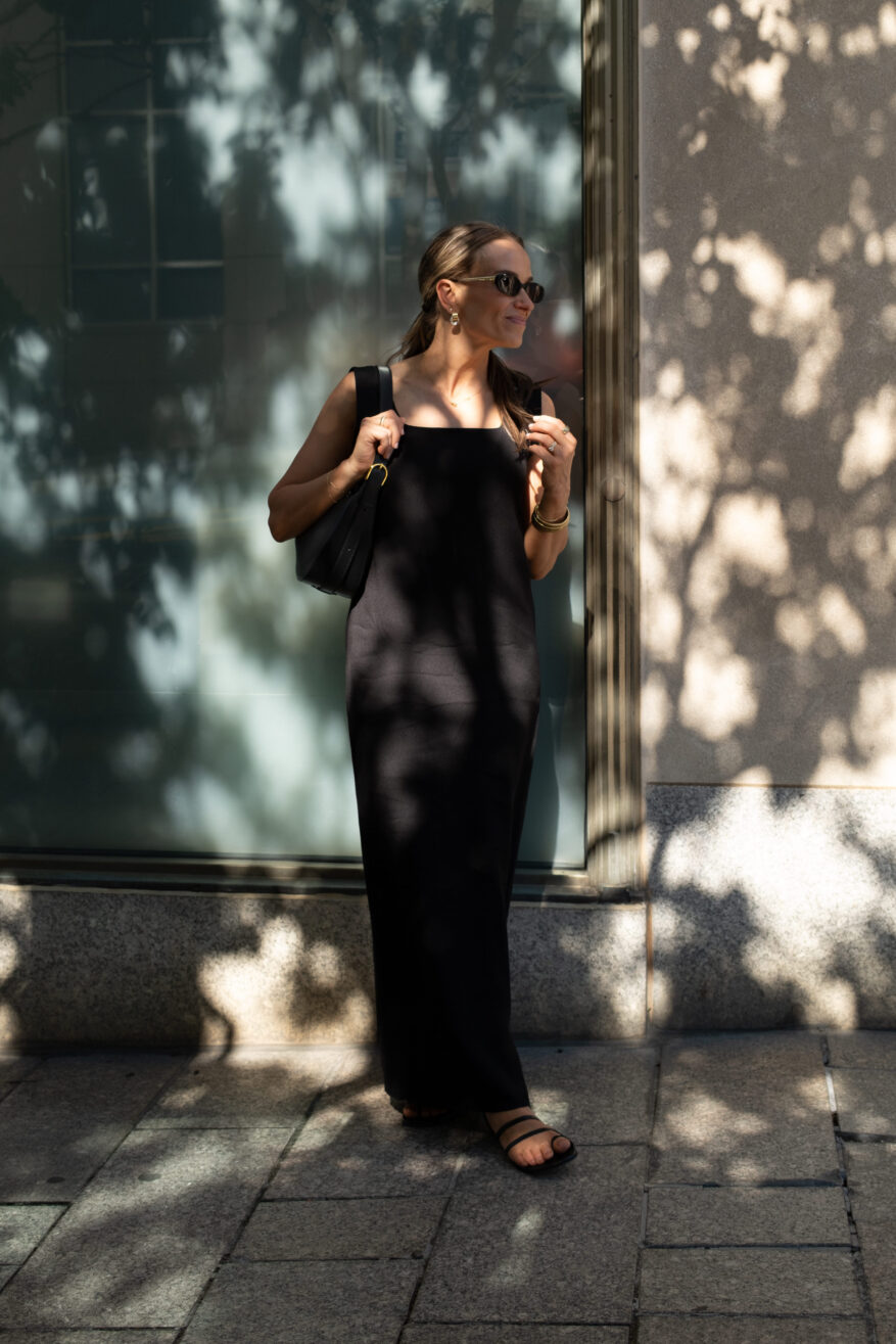 TeriLyn Adams wearing a simple black dress with gold jewelry and black strappy sandals