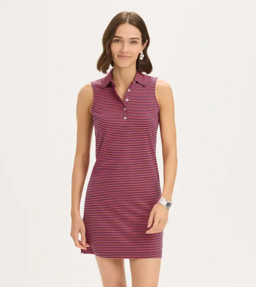 woman wearing striped polo mini dress for what to wear to a golf tournament