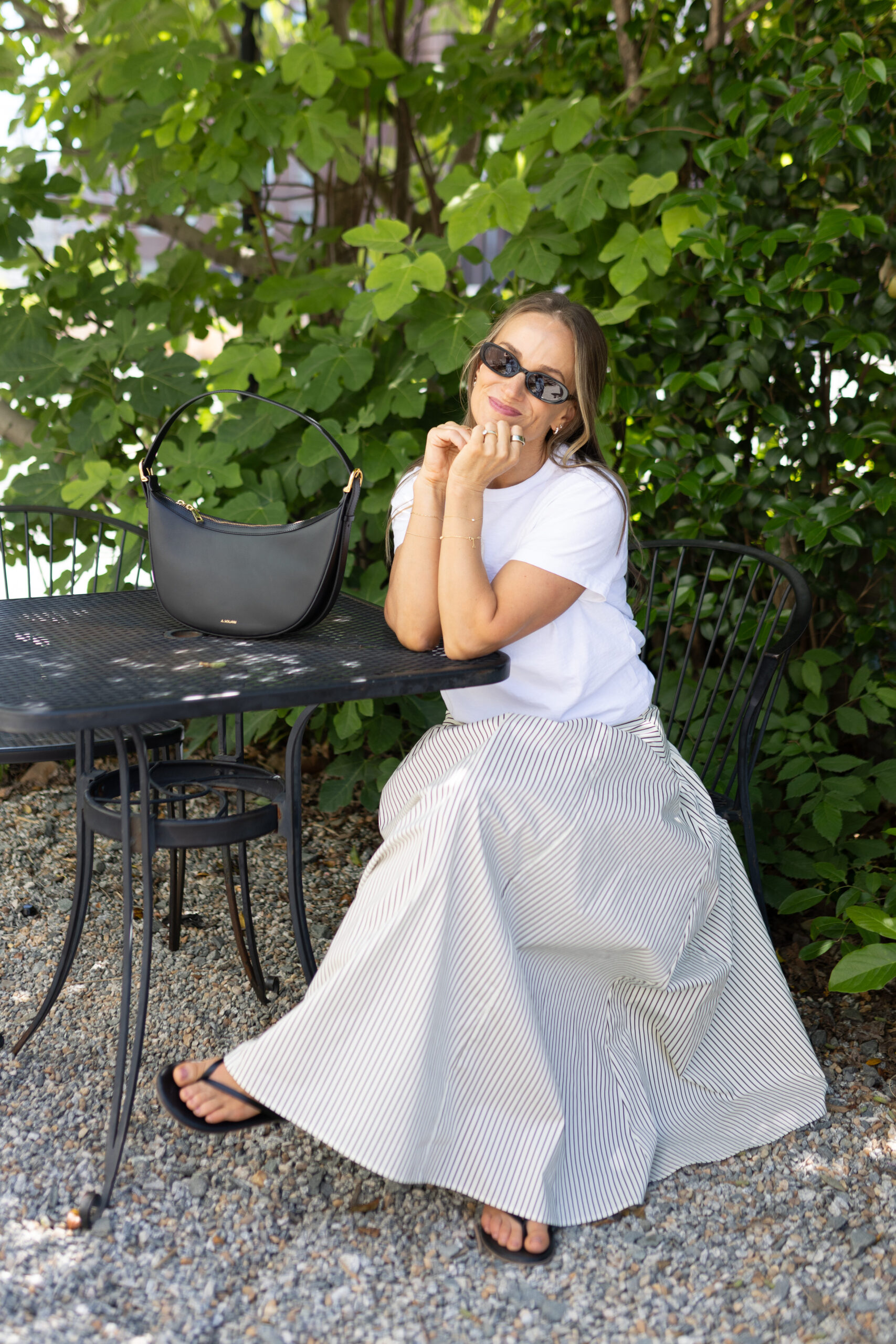 TeriLyn Adams wearing a white tee and maxi skirt and tkees flip flops