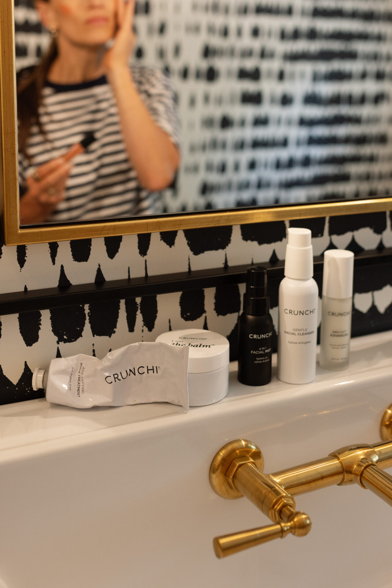 Crunchi skincare products lined up on TeriLyn Adams bathroom sink.