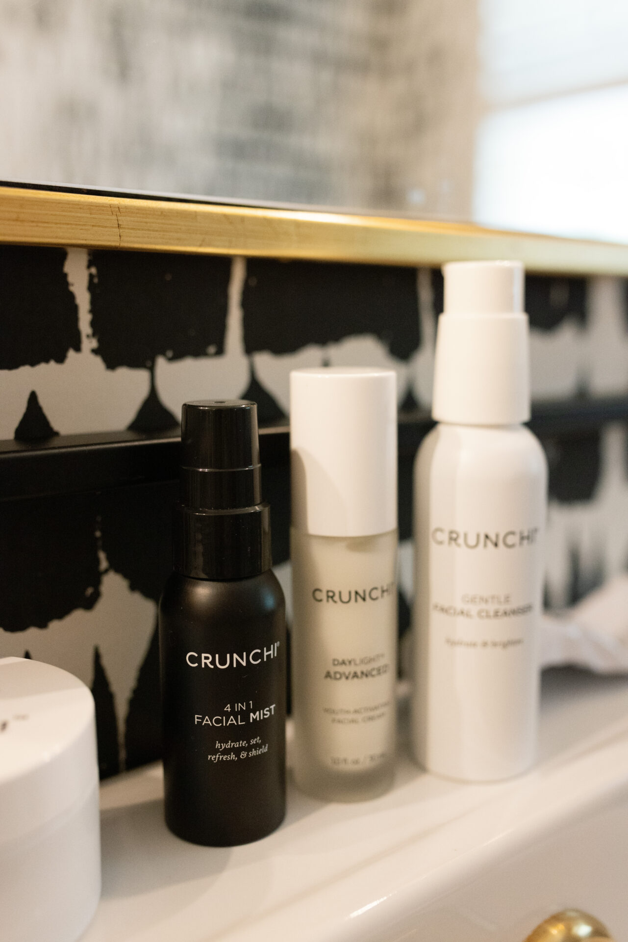 Crunchi skincare products lined up on TeriLyn Adams bathroom sink.
