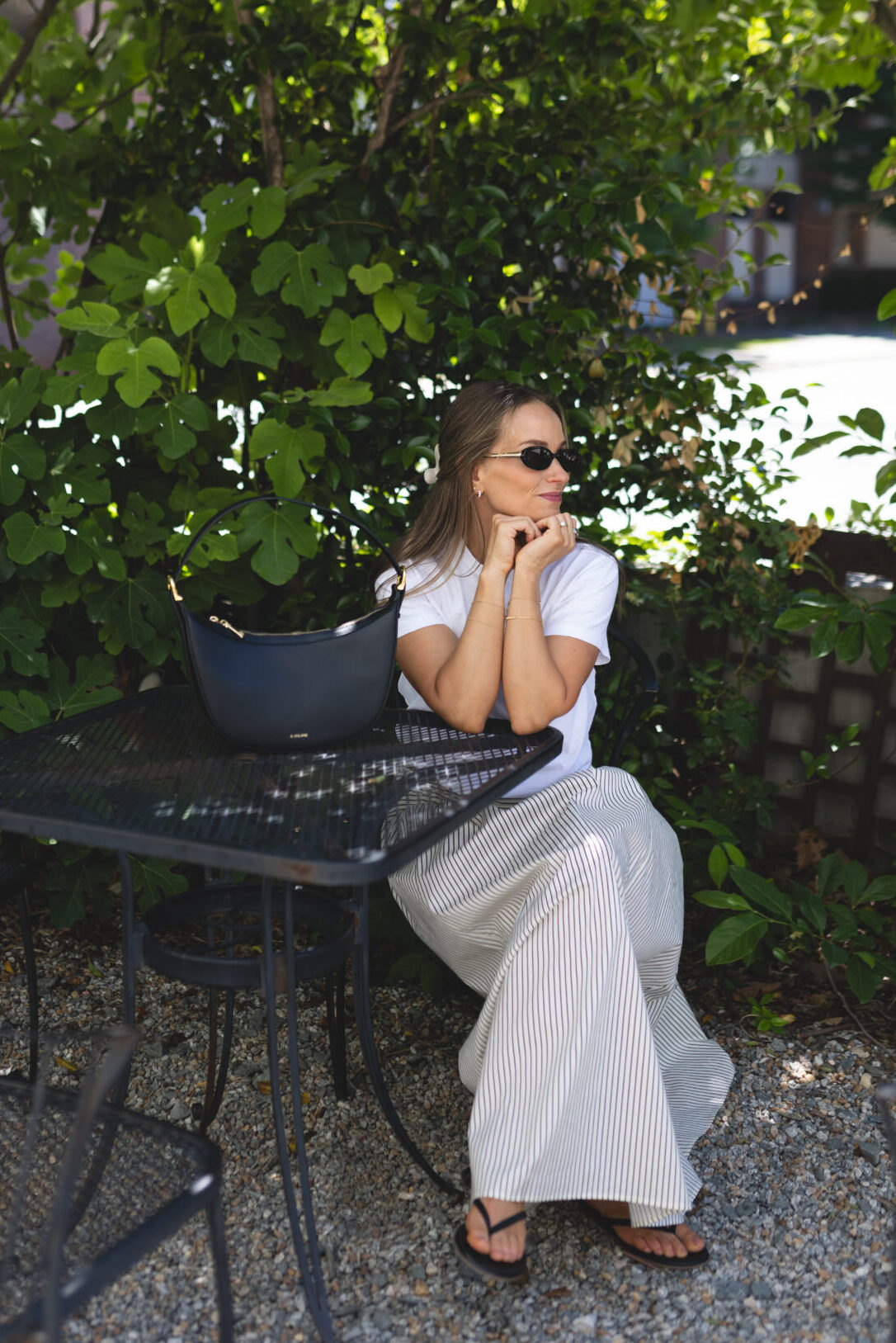 TeriLyn Adams wearing maxi skirt and white tee with sandals.