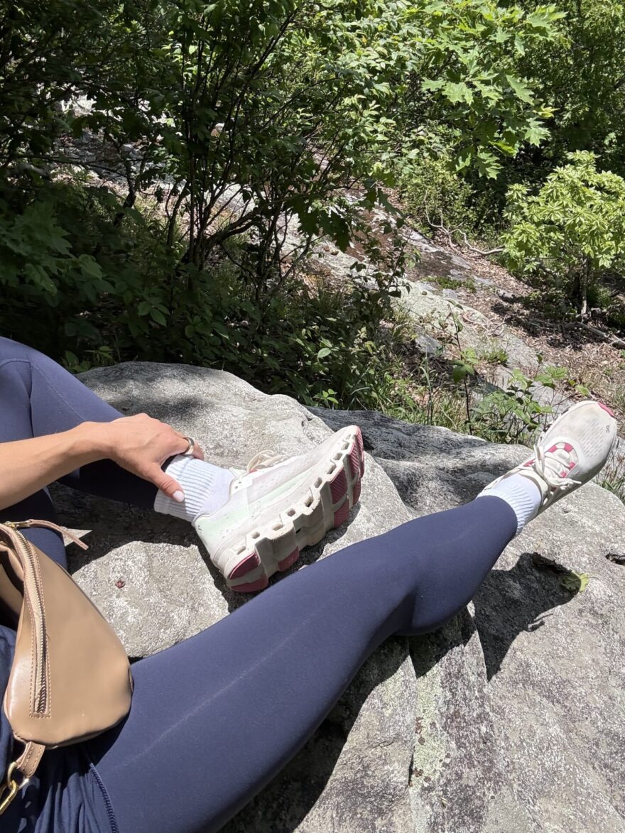 TeriLyn Adams wearing On Cloudmonster sneakers with leggings on a hike