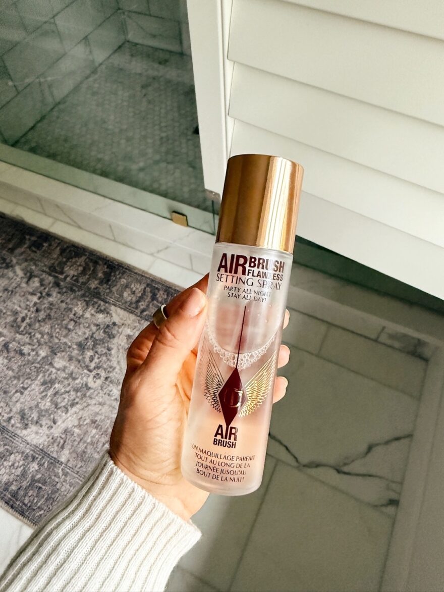 Charlotte Tilbury Airbrush Flawless Setting Spray held in hand, product shot