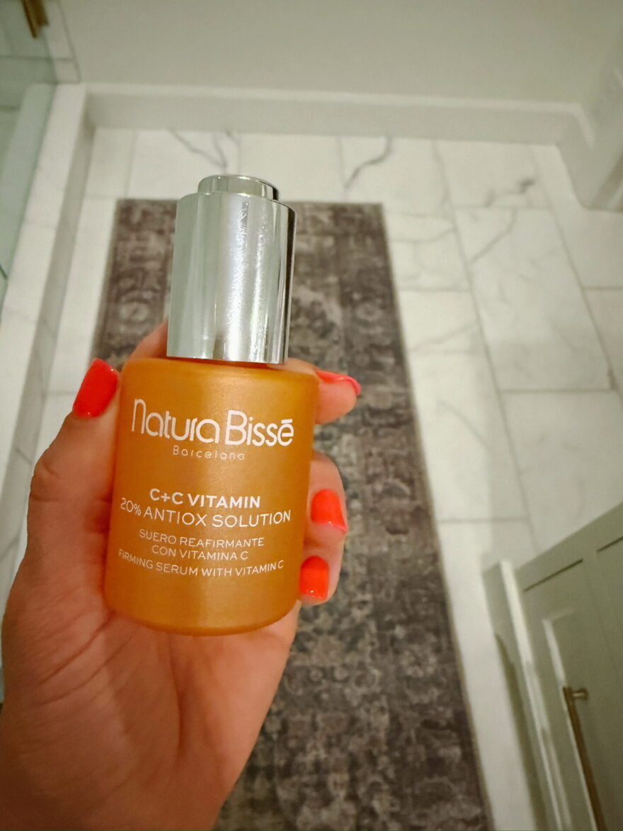TeriLyn Adams Natura Bissé C+C Vitamin 20% Antiox Solution serum held in hand, product shot