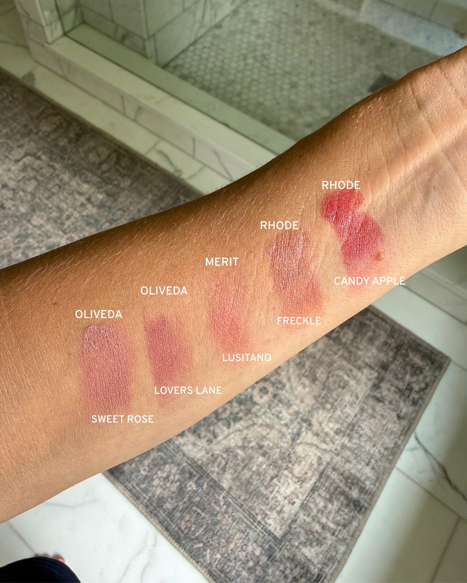 Cream blush swatches from multiple brands compared side by side on forearm