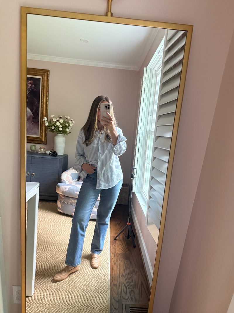 TeriLyn Adams wearing a striped button-down tucked into straight-leg jeans with loafers