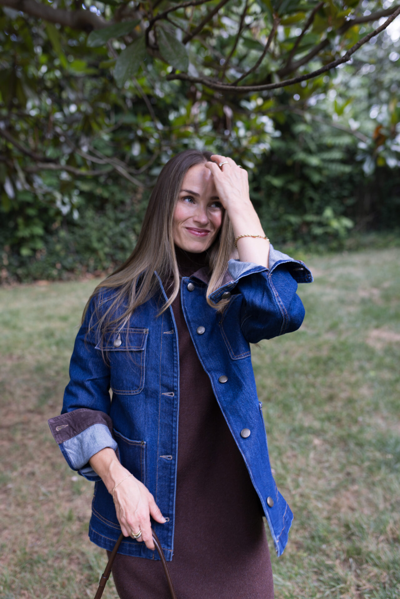 TeriLyn Adams wearing marine layer barn jacket over brown sweater dress.