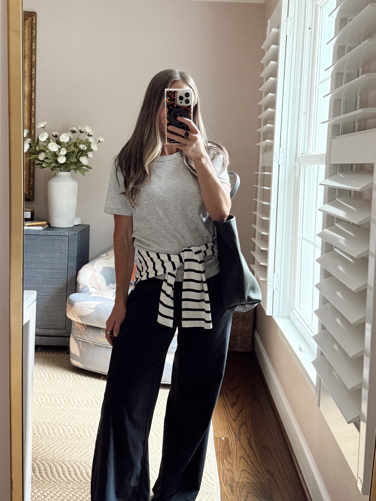 TeriLyn Adams in basic gray top with long sleeve stripe shirt around her waist for fall capsule wardrobe.