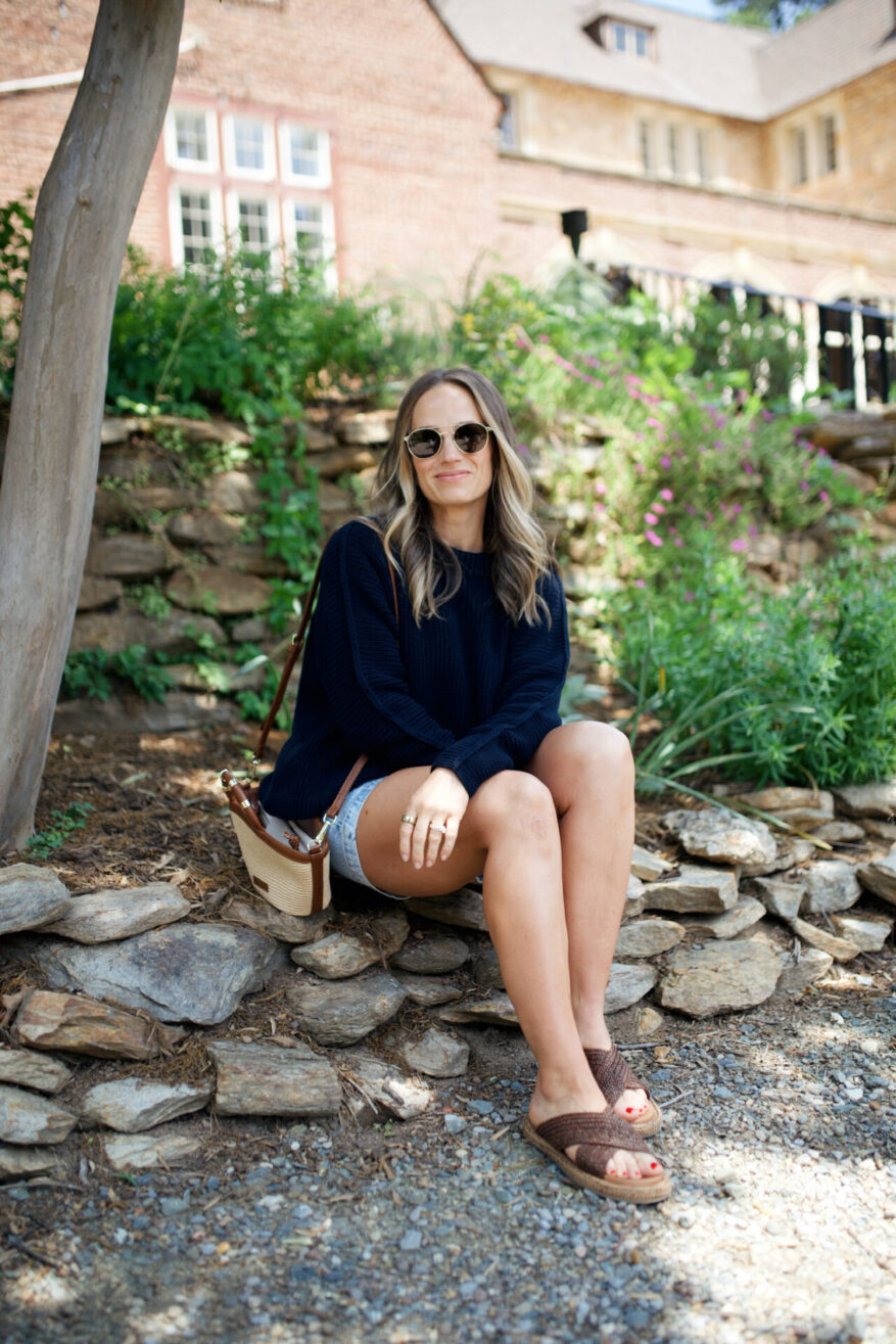 TeriLyn Adams wearing the Frank & Eileen Montecito sweater in navy with denim shorts and woven slide sandals