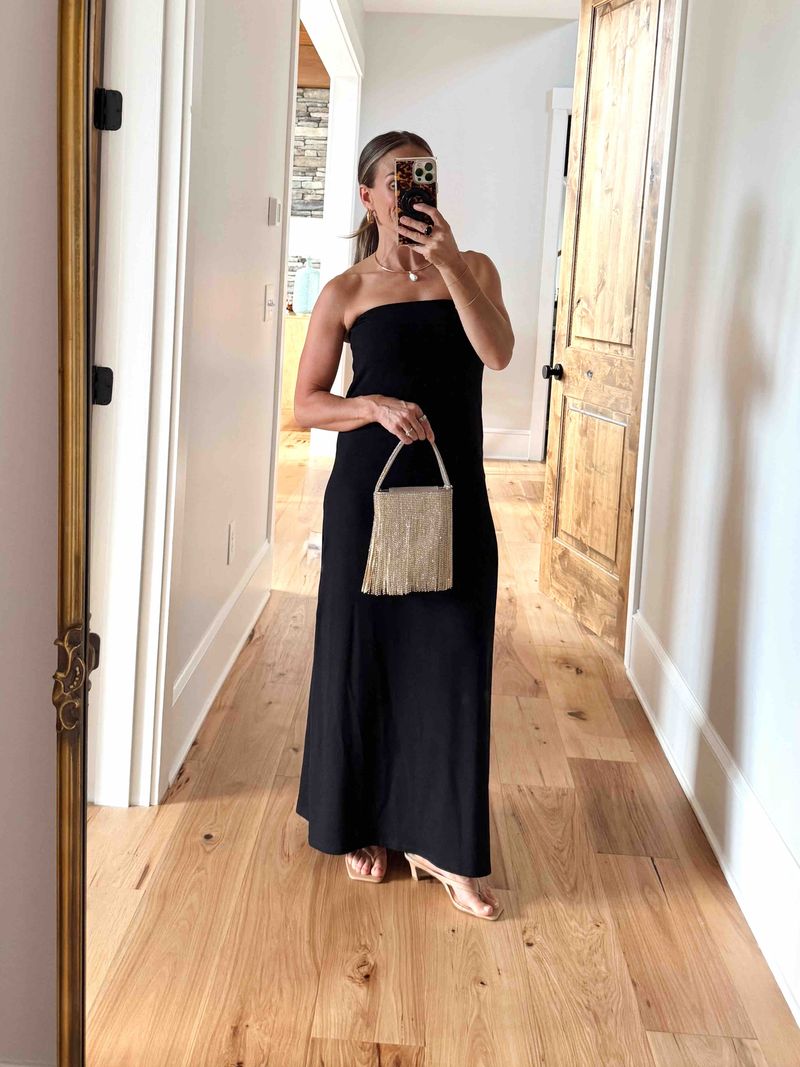TeriLyn Adams wearing a black Sold Out NYC strapless maxi dress with a crystal fringe bag and nude heeled sandals